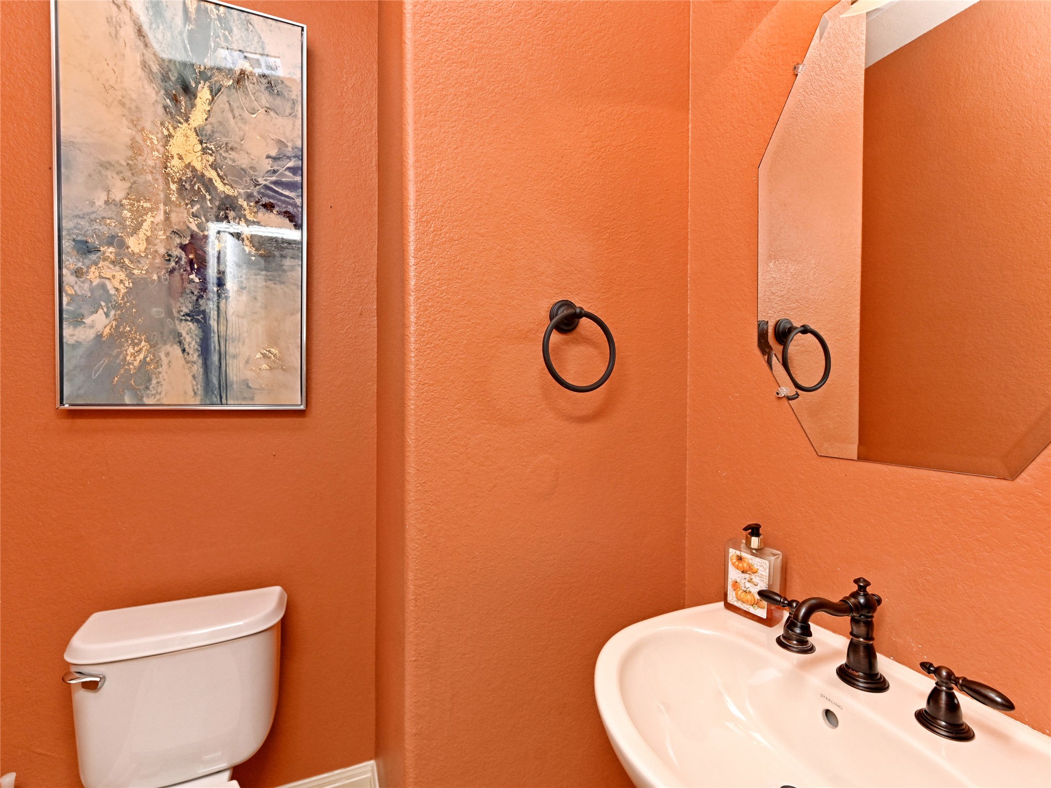 230 Sunrise Ridge Loop Austin, TX 78738 - Photo 26 of 27 A well-appointed powder room features a classic pedestal sink and ample counter space.
