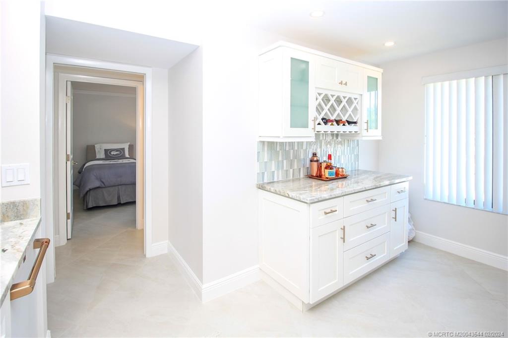 4440 Northeast Sandpebble Trace, Unit 201 Stuart, FL 34996 - Photo 13 of 23 a bedroom with furniture and a window