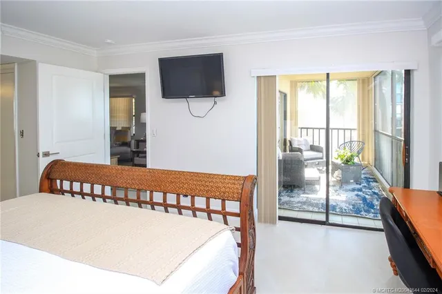 a view of a bedroom with furniture and a flat screen tv