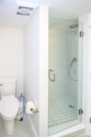 a bathroom with a toilet and a shower