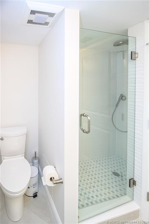 4440 Northeast Sandpebble Trace, Unit 201 Jensen Beach, FL 34957 - Photo 19 of 32 a bathroom with a toilet and a shower