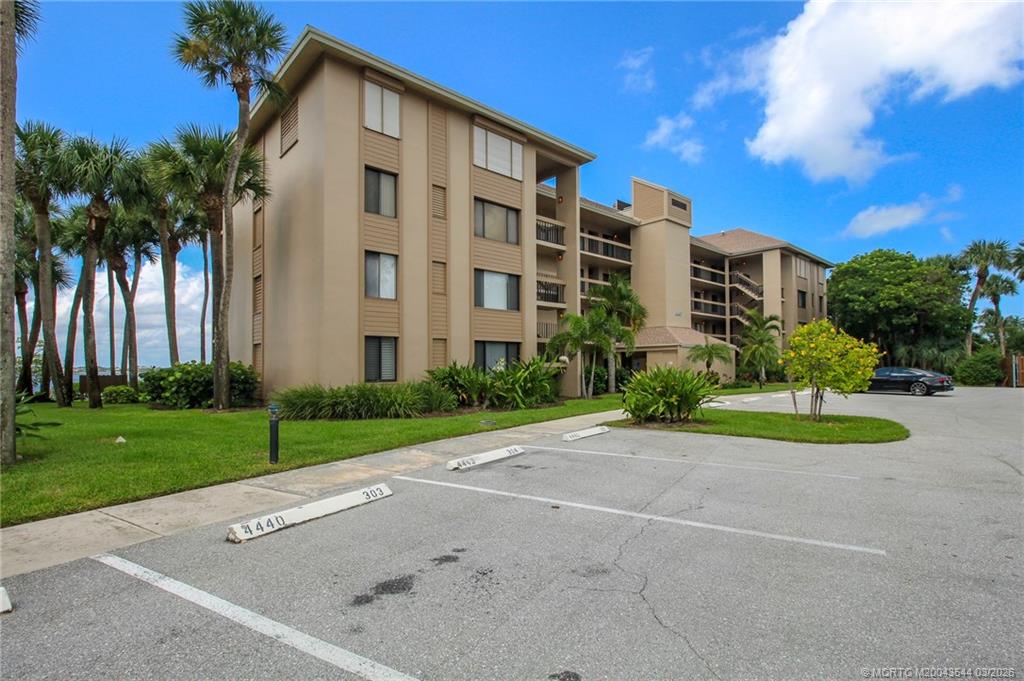 4440 Northeast Sandpebble Trace, Unit 201 Jensen Beach, FL 34957 - Photo 27 of 32 a view of a buildings with a yard