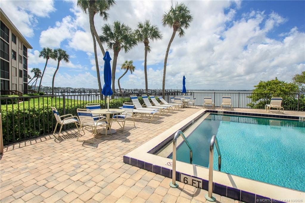 4440 Northeast Sandpebble Trace, Unit 201 Jensen Beach, FL 34957 - Photo 30 of 32 a view of swimming pool with chairs