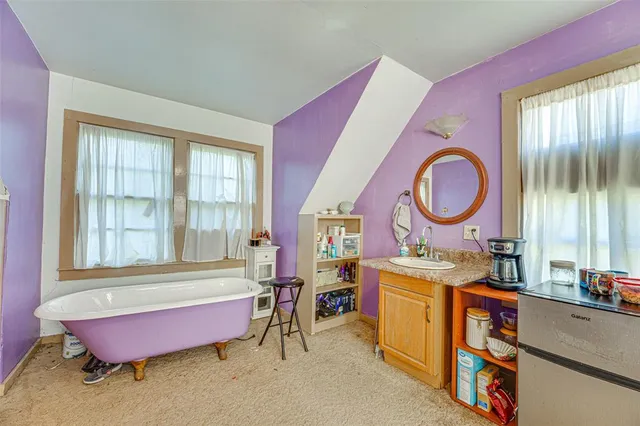 a living room with furniture a rug and a window