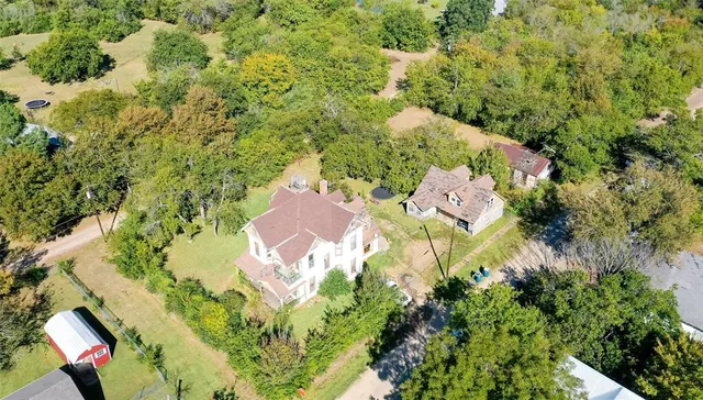 an aerial view of residential house with yard and swimming pool