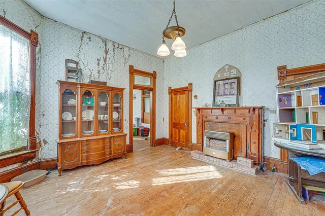 a living room with fireplace furniture and a window