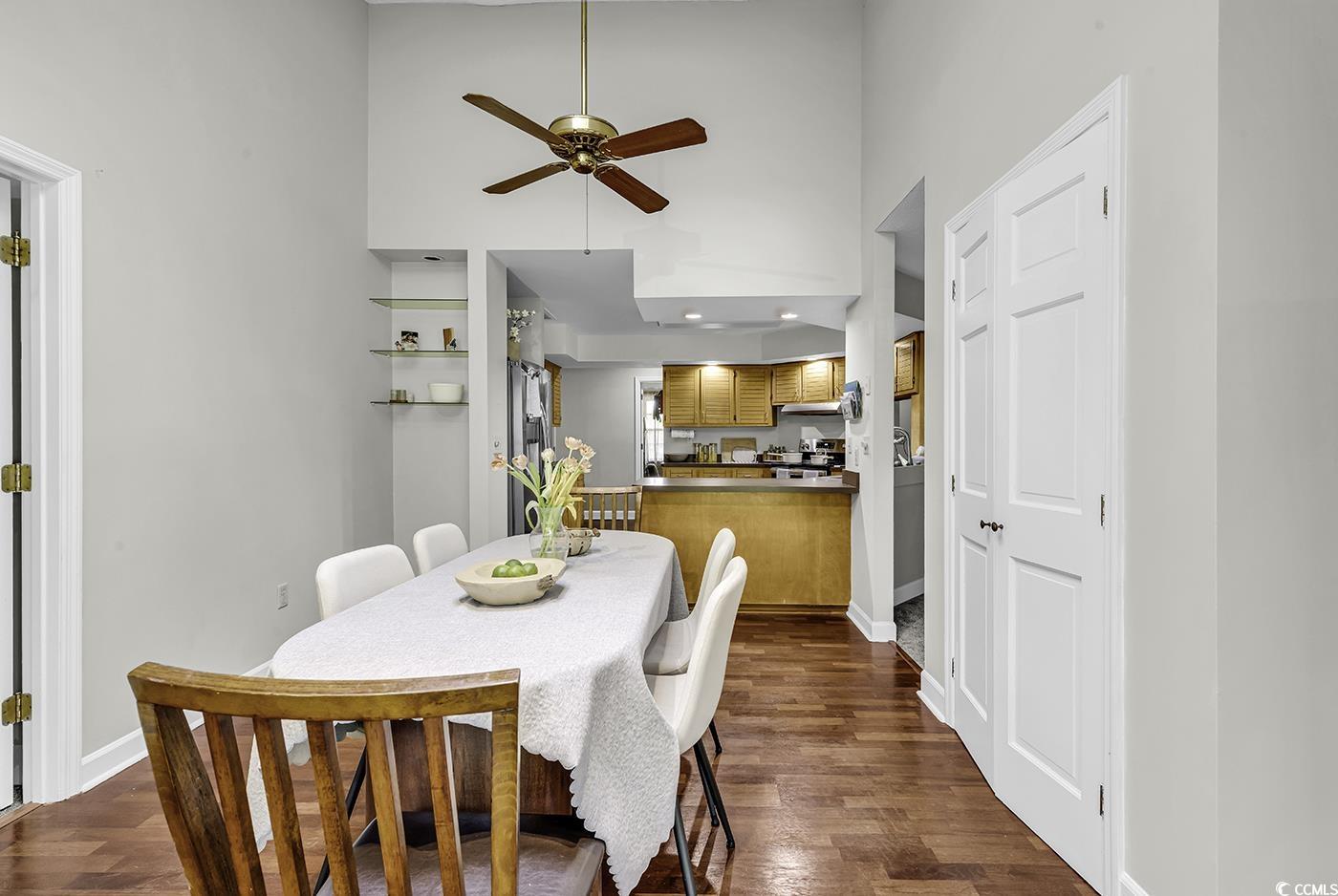 1305 Forest View Road Conway, SC 29526 - Photo 12 of 40 Dining space featuring ceiling fan, dark wood-style floors, baseboards, and a high ceiling