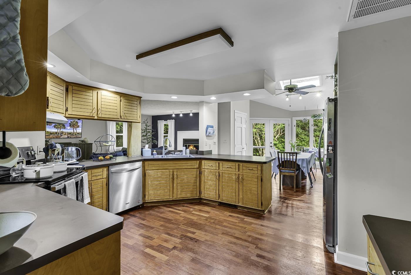 1305 Forest View Road Conway, SC 29526 - Photo 14 of 40 Kitchen with dishwasher, a sink, dark countertops, ceiling fan, and a peninsula