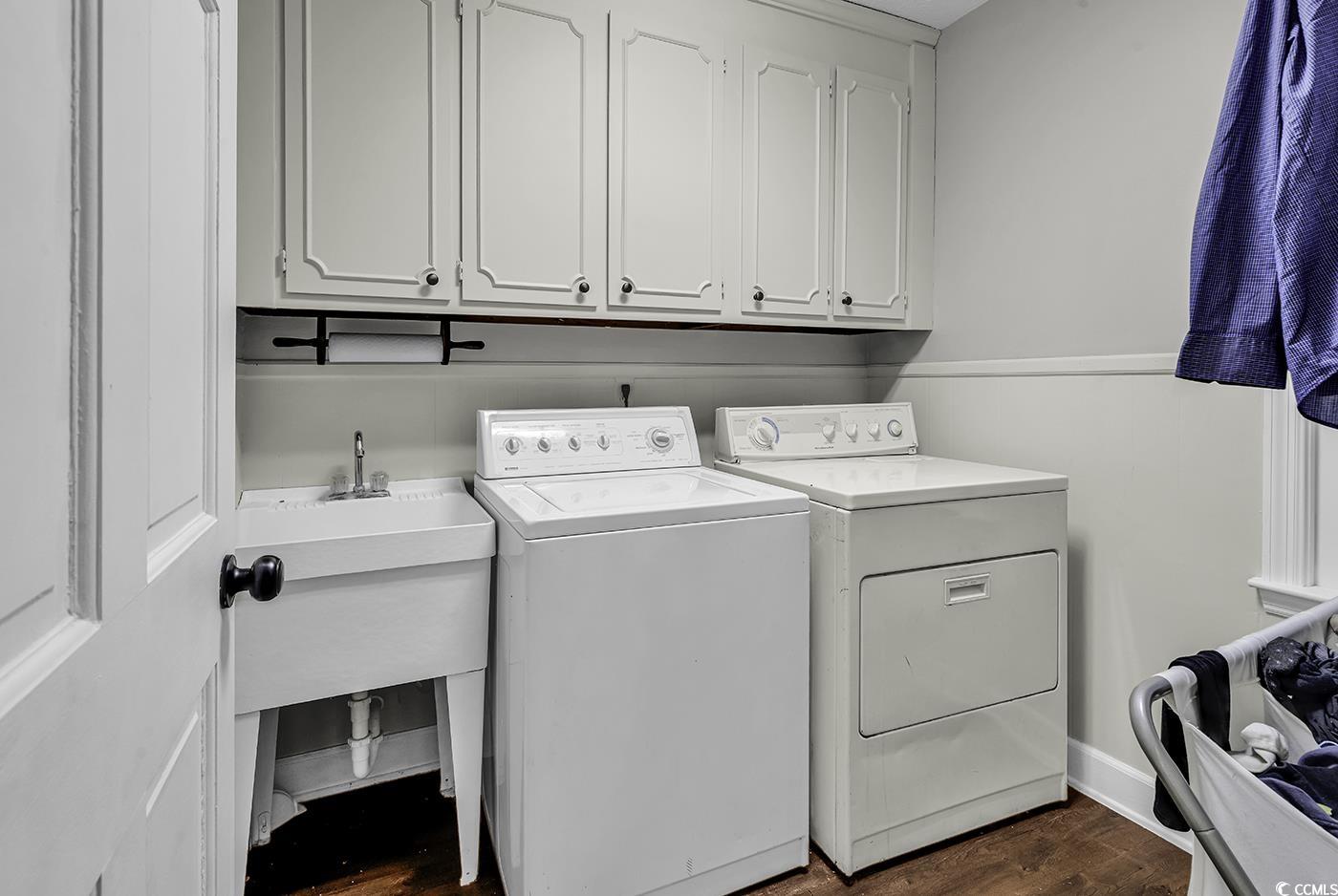 1305 Forest View Road Conway, SC 29526 - Photo 17 of 40 Washroom featuring separate washer and dryer, cabinet space, and dark wood-style flooring