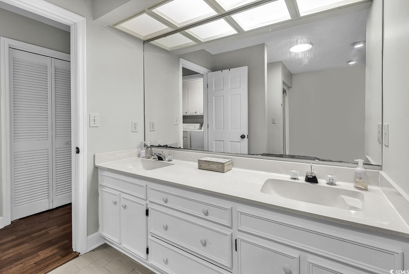 1305 Forest View Road Conway, SC 29526 - Photo 24 of 40 Bathroom featuring a closet, double vanity, washer / clothes dryer, and baseboards