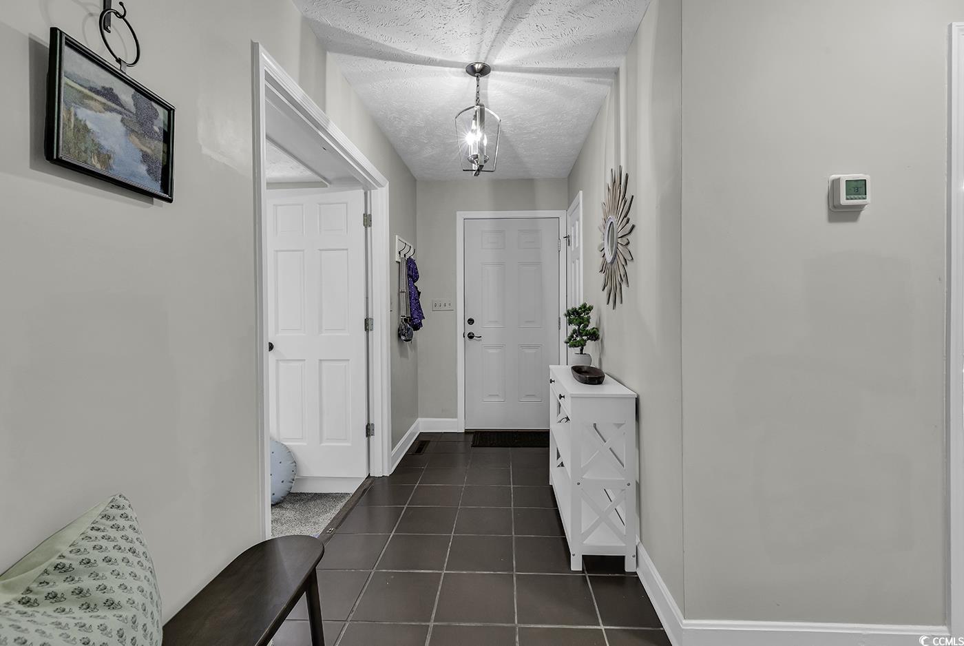 1305 Forest View Road Conway, SC 29526 - Photo 3 of 40 Foyer entrance featuring baseboards and dark tile patterned floors