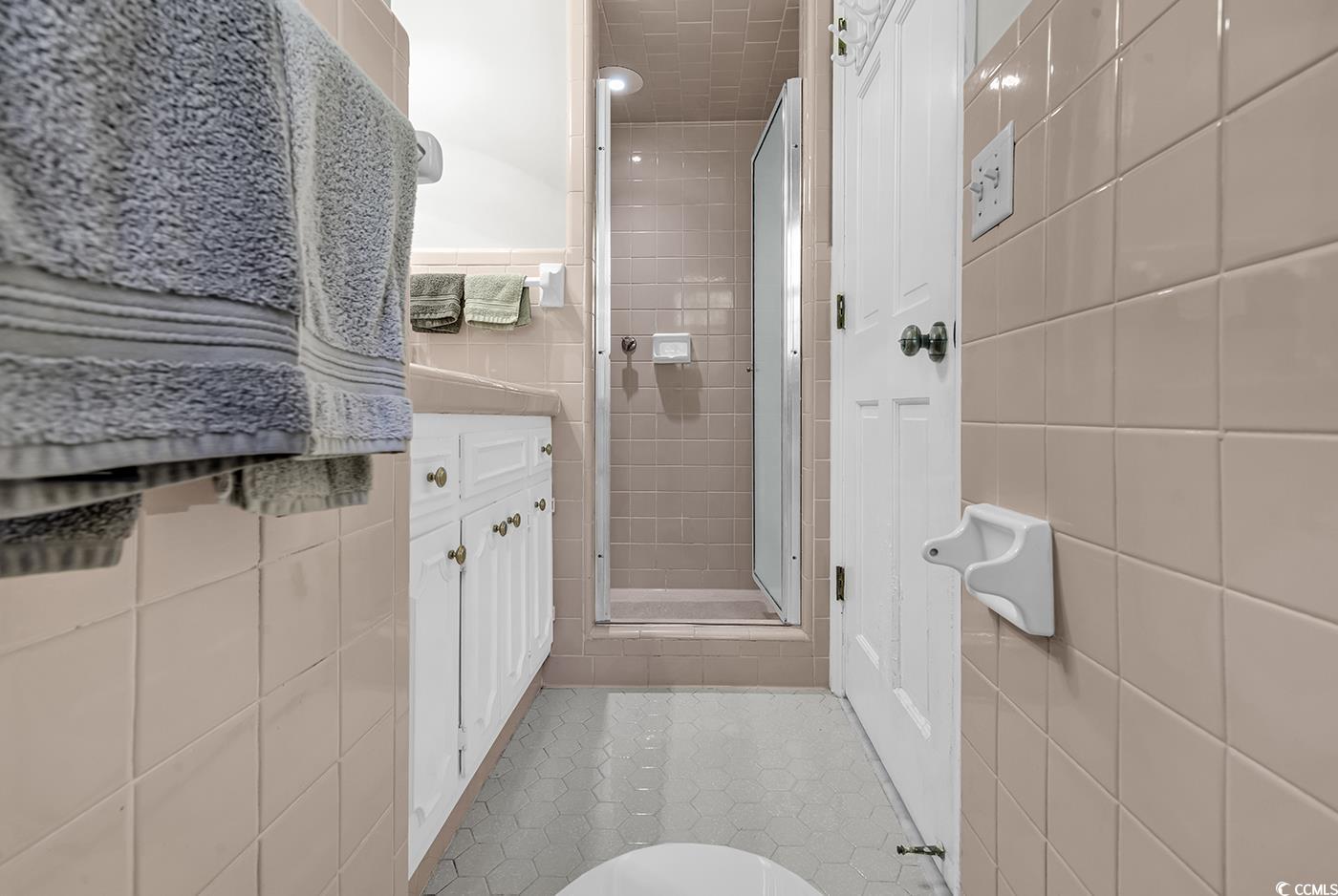 1305 Forest View Road Conway, SC 29526 - Photo 31 of 40 Bathroom featuring tile walls, a stall shower, tile patterned flooring, vanity, and toilet