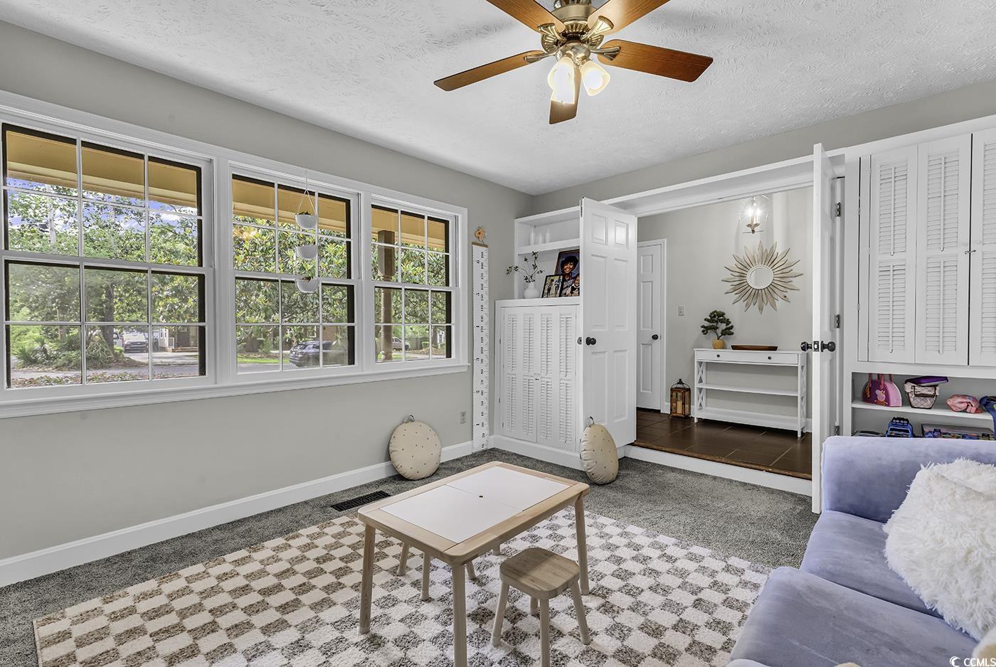 1305 Forest View Road Conway, SC 29526 - Photo 5 of 40 Carpeted living area featuring baseboards, ceiling fan, and a textured ceiling