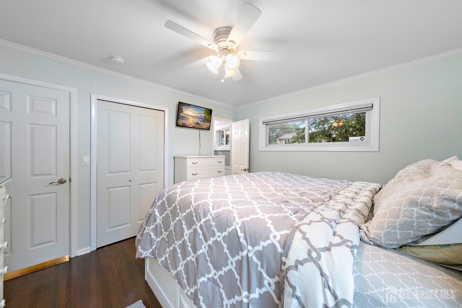 8 Beverly Drive Old Bridge, NJ 08857 - Photo 13 of 34 a bedroom with a large bed and a chandelier