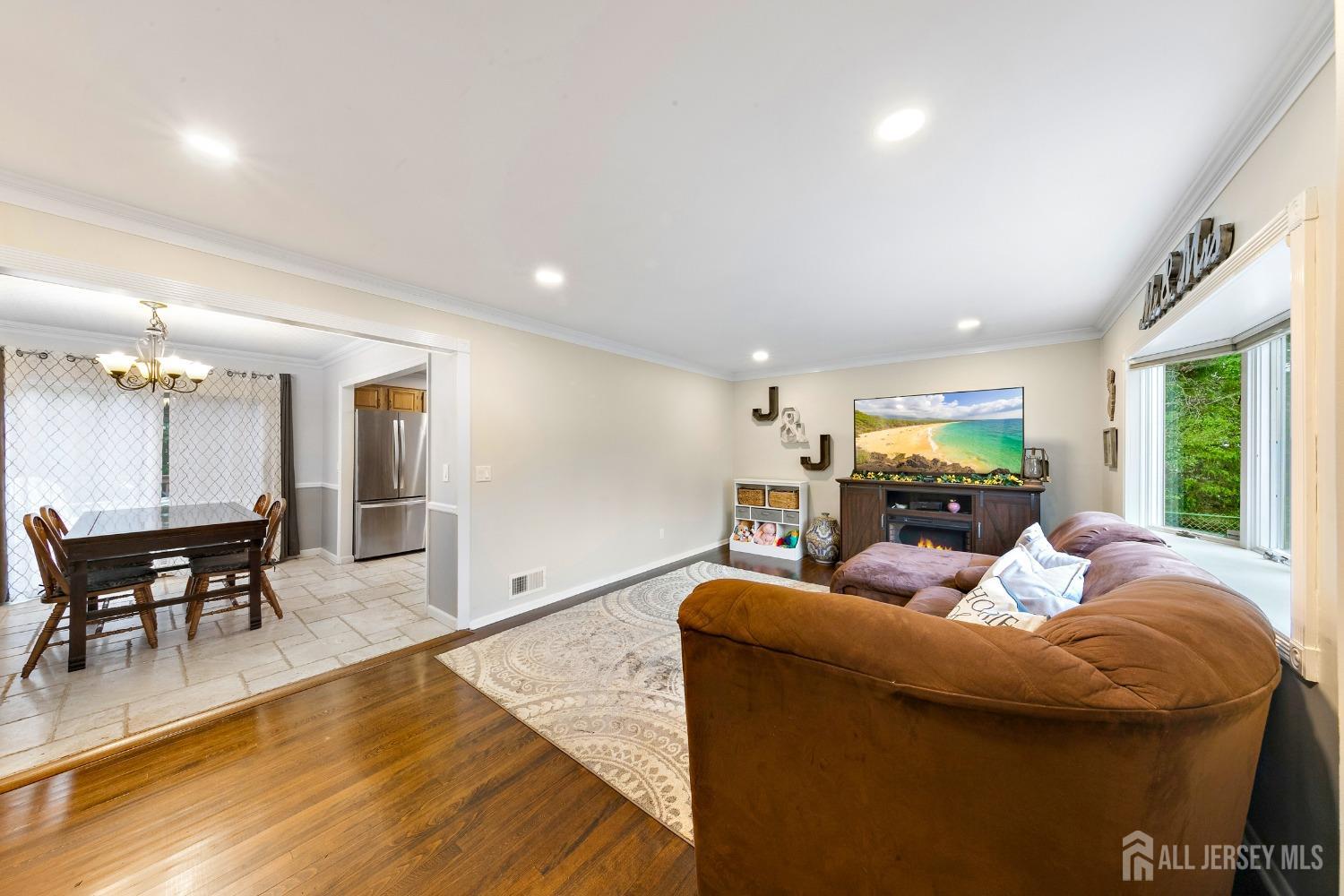 8 Beverly Drive Old Bridge, NJ 08857 - Photo 4 of 34 a living room with furniture wooden floor and a dining table