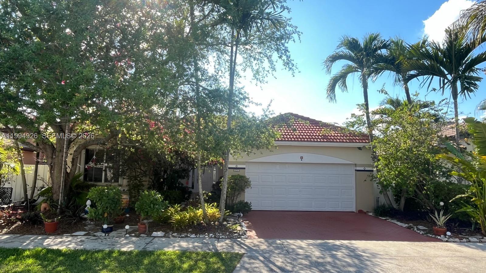 656 Northwest 129th Place Miami, FL 33182 - Photo 1 of 36 a front view of a house with a yard