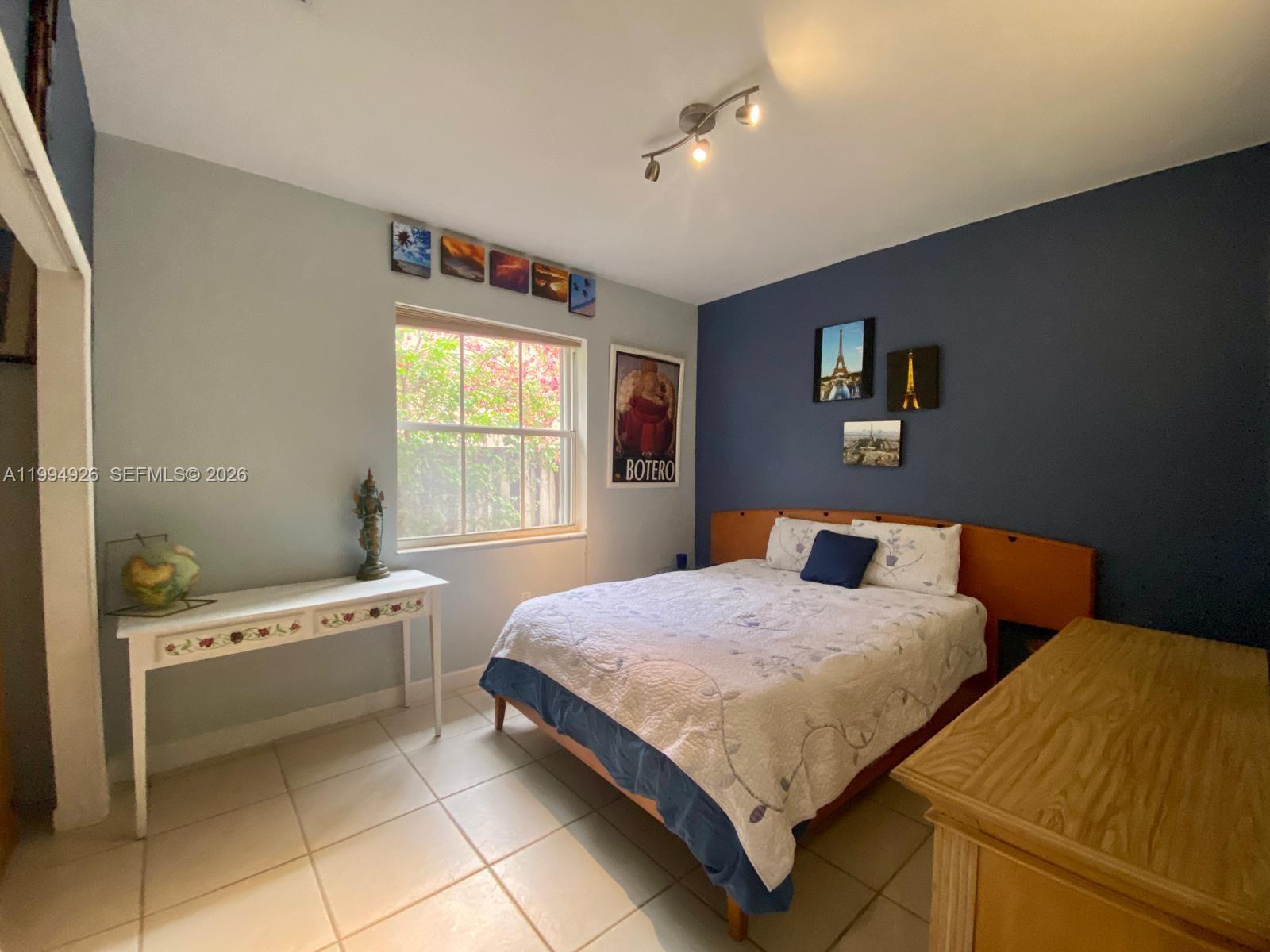 656 Northwest 129th Place Miami, FL 33182 - Photo 15 of 36 a bedroom with a bed and a window