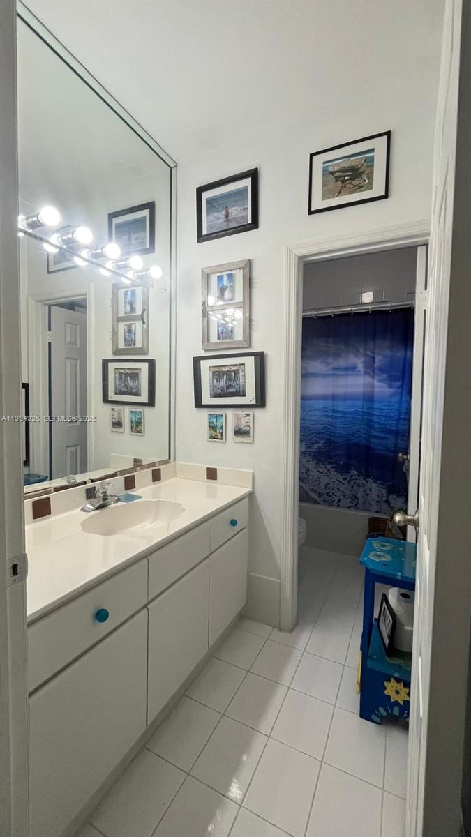 656 Northwest 129th Place Miami, FL 33182 - Photo 17 of 36 a spacious bathroom with a double vanity sink and a mirror