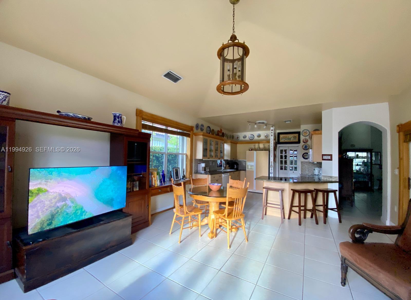 656 Northwest 129th Place Miami, FL 33182 - Photo 21 of 36 a living room with furniture and a flat screen tv