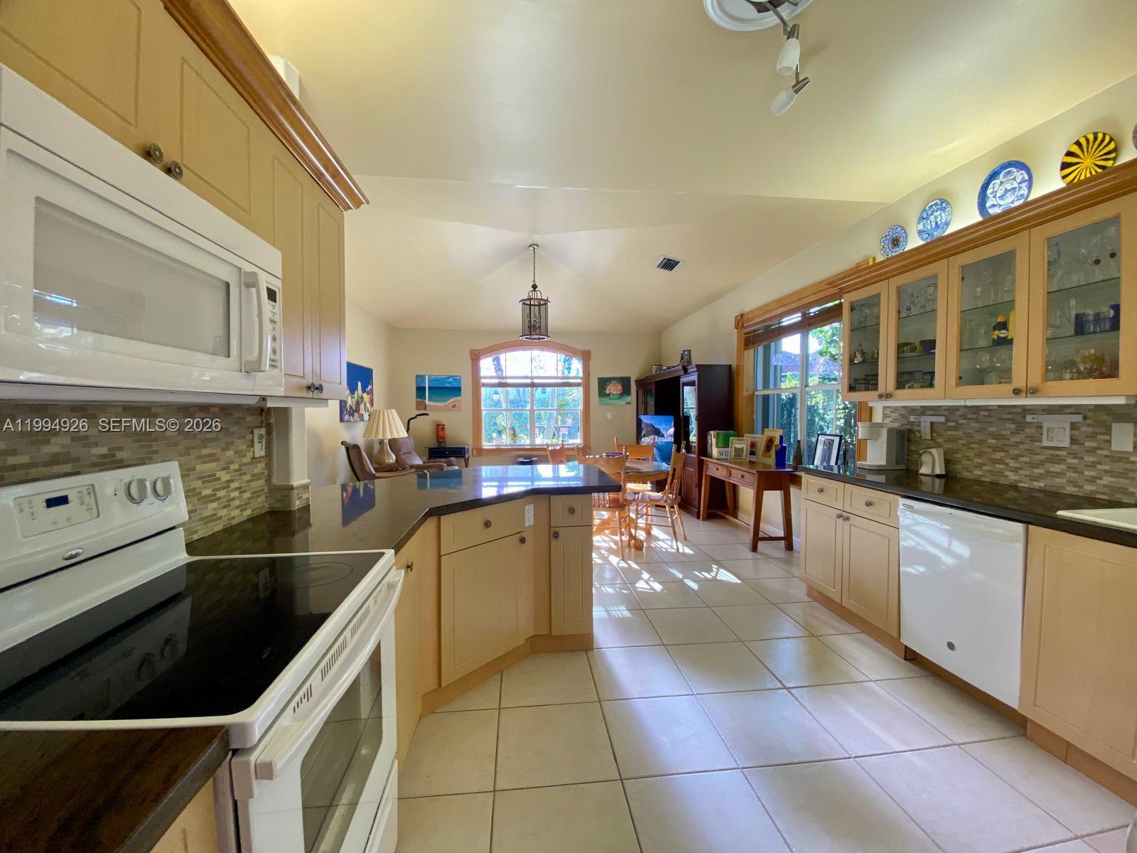 656 Northwest 129th Place Miami, FL 33182 - Photo 24 of 36 a kitchen with stainless steel appliances granite countertop a sink and cabinets