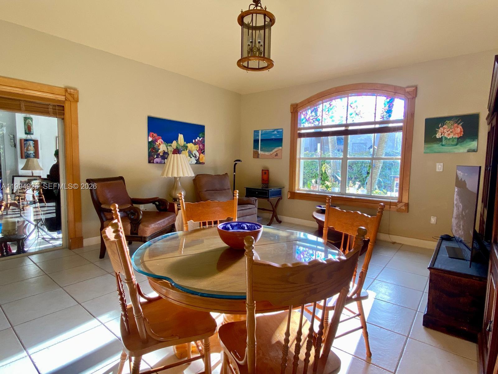 656 Northwest 129th Place Miami, FL 33182 - Photo 27 of 36 a dining room with furniture a chandelier and window