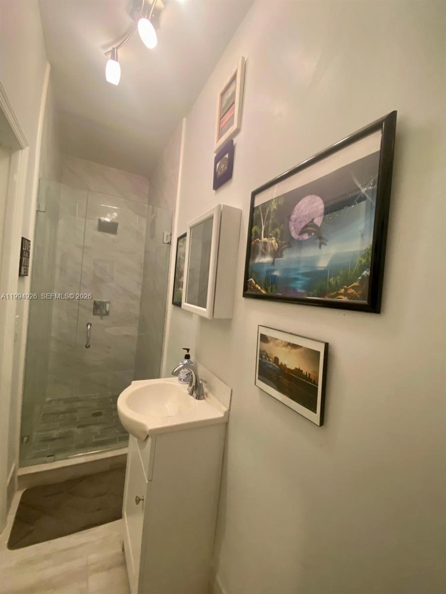 656 Northwest 129th Place Miami, FL 33182 - Photo 28 of 36 a bathroom with a sink and a mirror