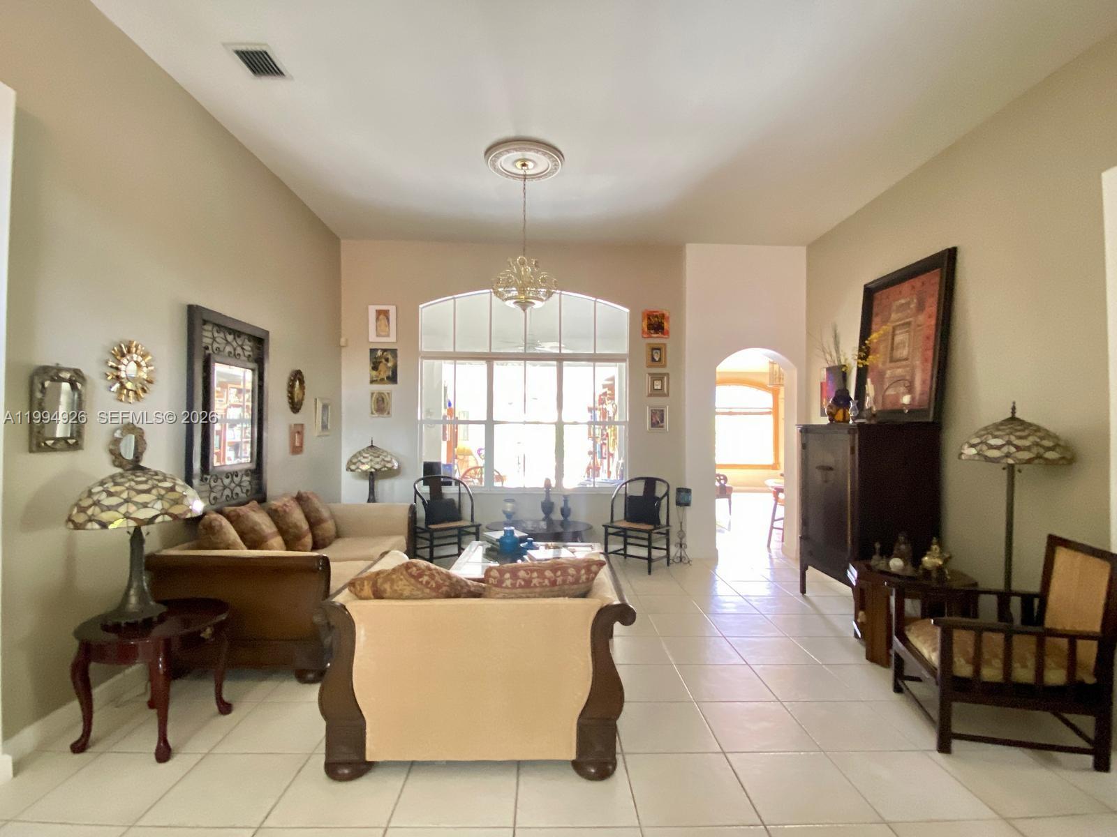 656 Northwest 129th Place Miami, FL 33182 - Photo 3 of 36 a living room with furniture and a large window