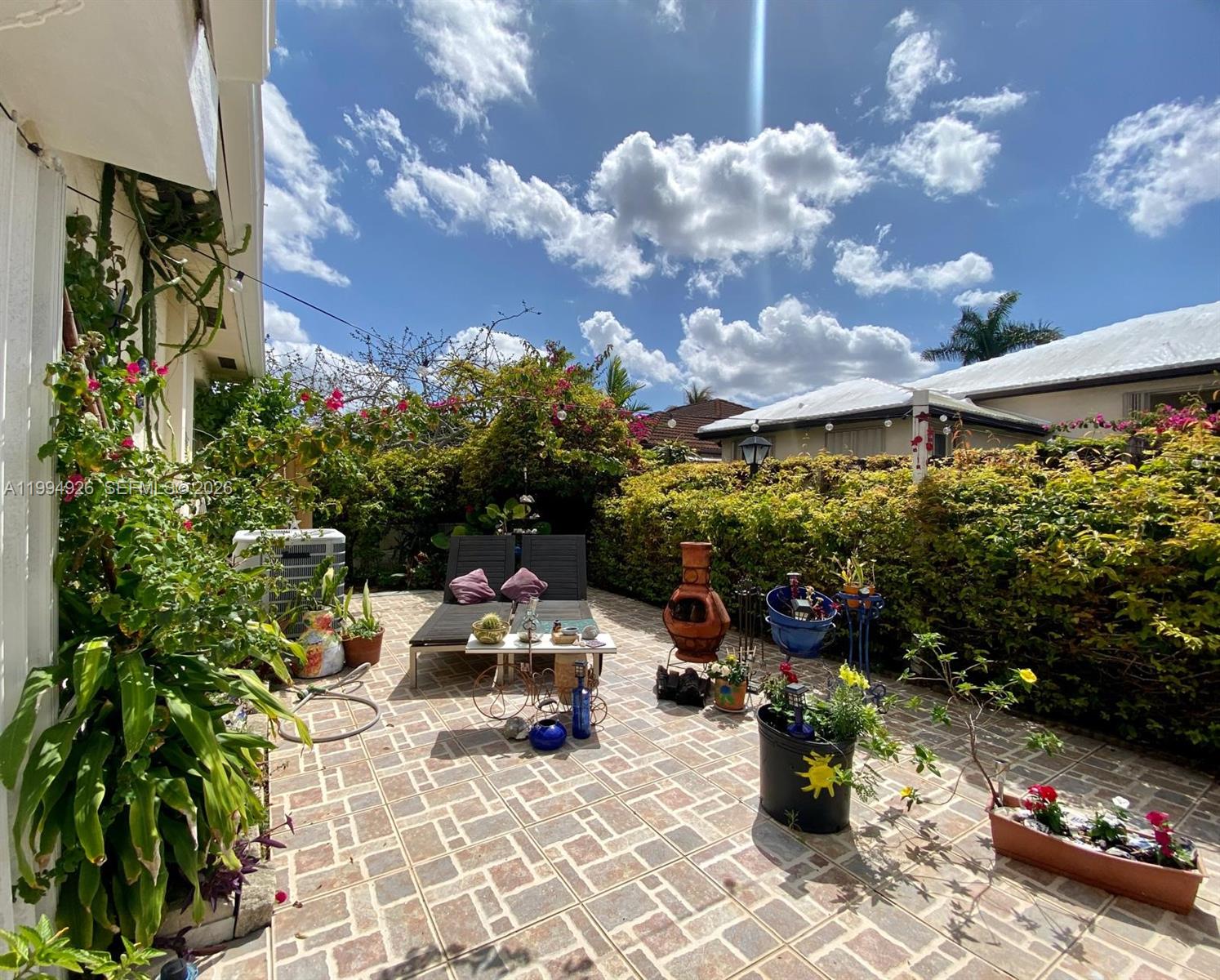 656 Northwest 129th Place Miami, FL 33182 - Photo 32 of 36 a view of a patio with table and chairs and potted plants