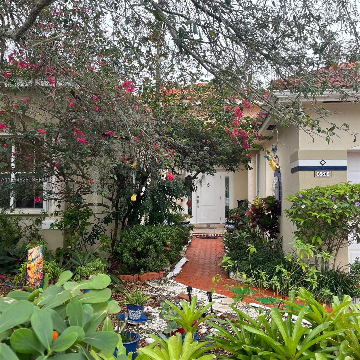 656 Northwest 129th Place Miami, FL 33182 - Photo 34 of 36 a front view of a house with a yard