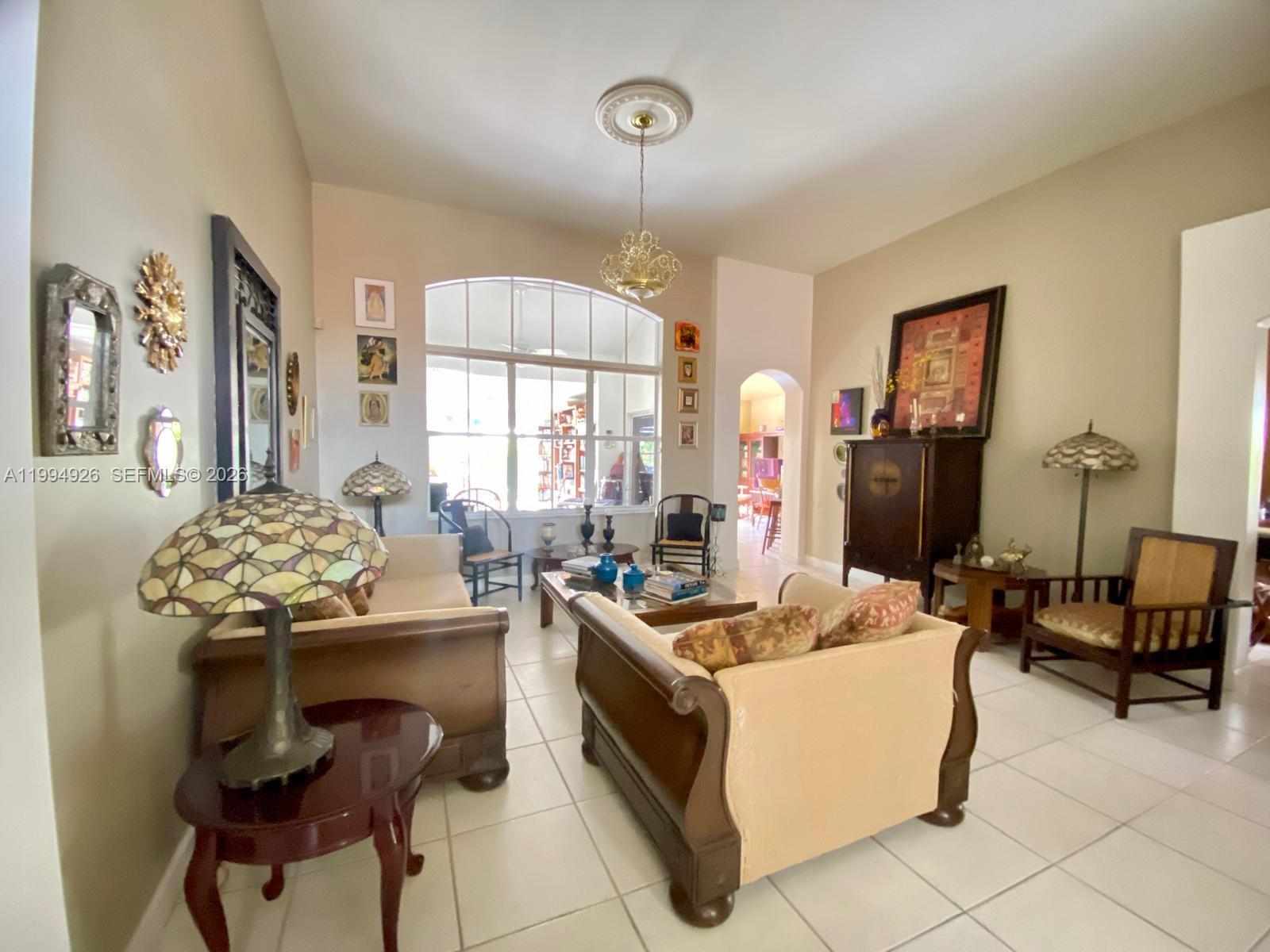 656 Northwest 129th Place Miami, FL 33182 - Photo 4 of 36 a living room with furniture and a window