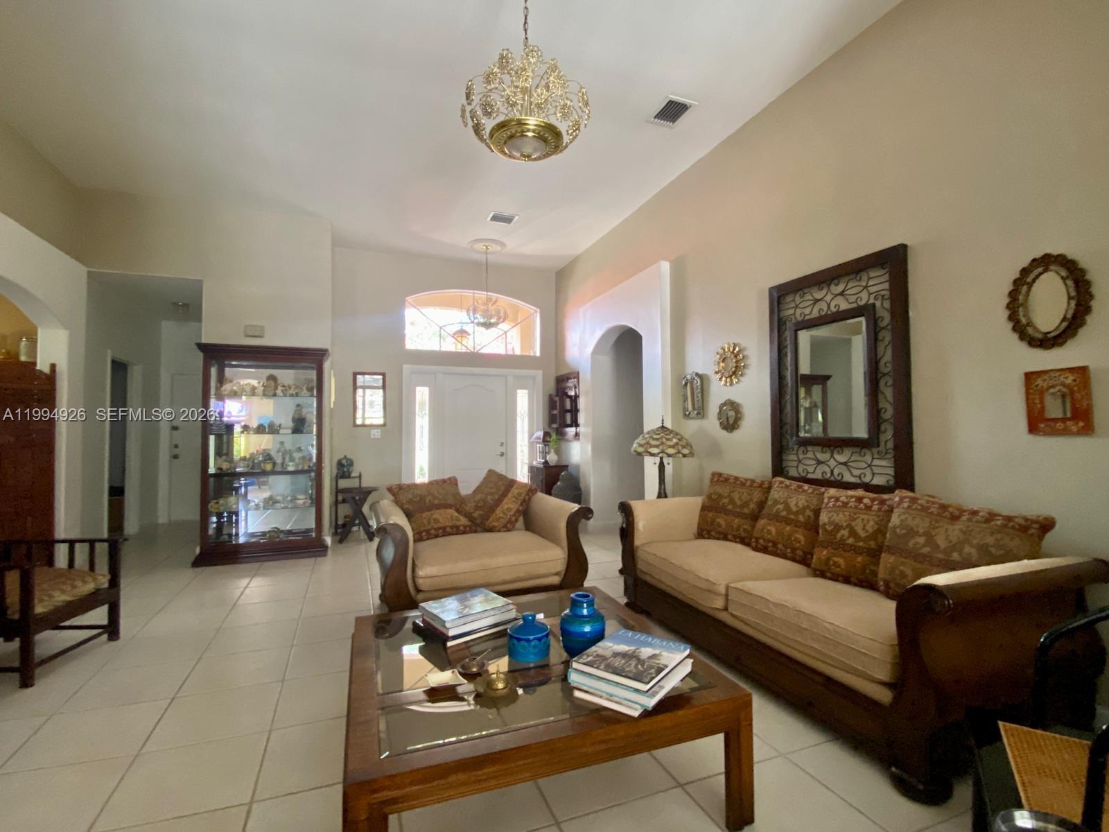 656 Northwest 129th Place Miami, FL 33182 - Photo 6 of 36 a living room with furniture a rug and a window