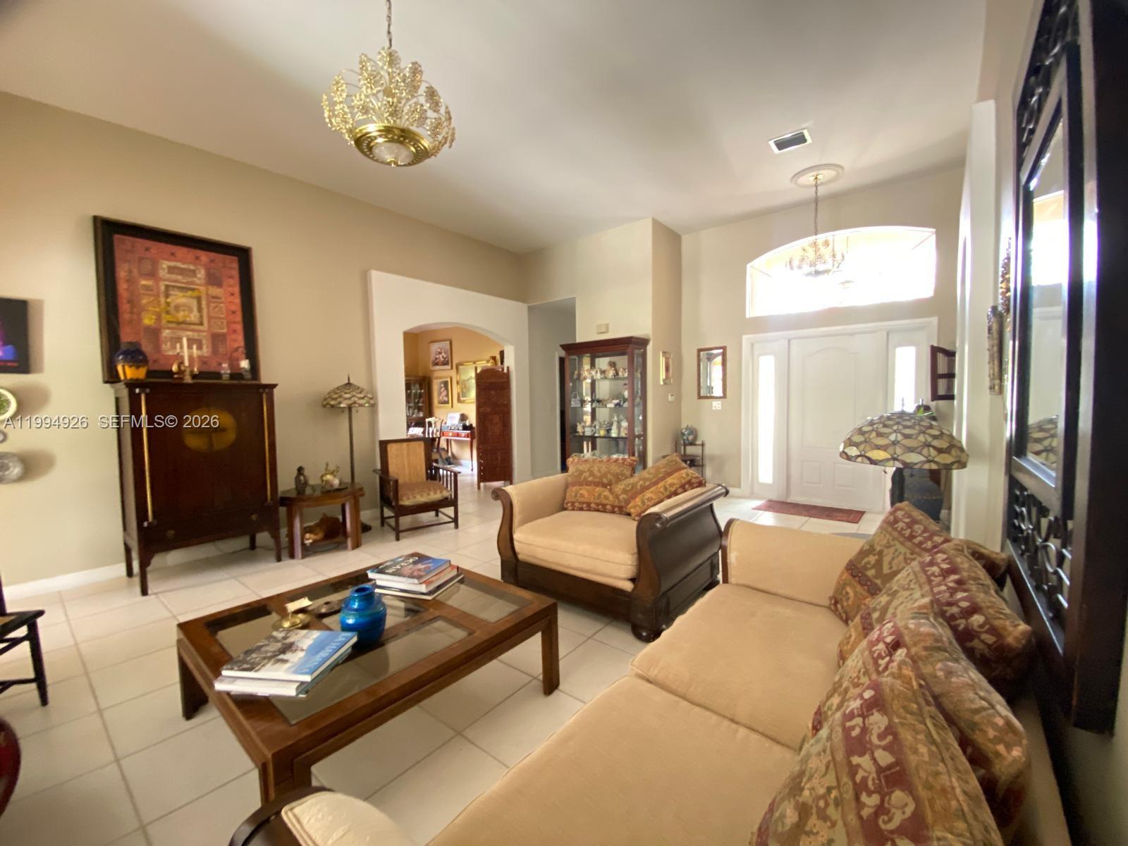 656 Northwest 129th Place Miami, FL 33182 - Photo 7 of 36 a living room with furniture and a chandelier