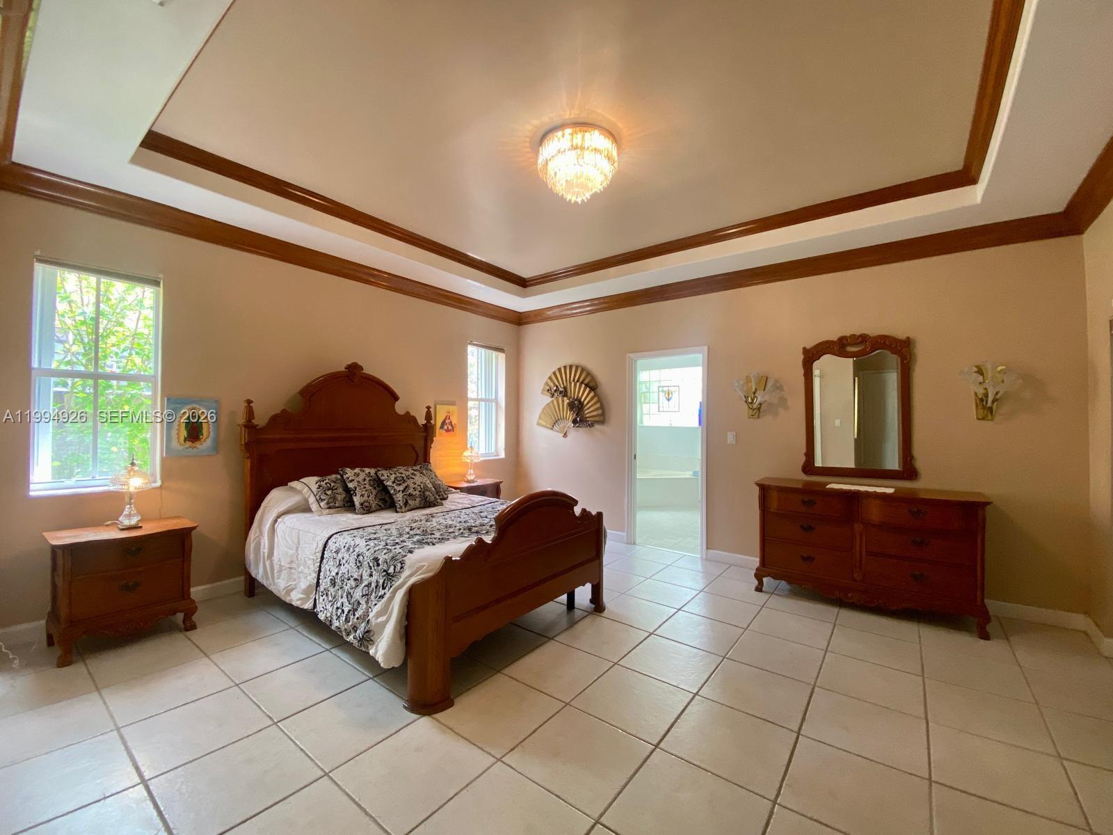 656 Northwest 129th Place Miami, FL 33182 - Photo 9 of 36 a bedroom with a bed and window