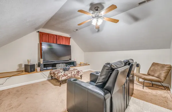 a living room with lots of furniture and a wooden floor