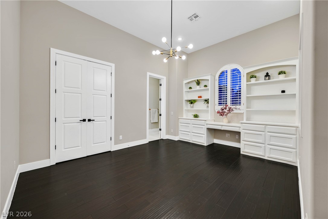 6 Rue Du Ville Henderson, NV 89011 - Photo 62 of 99 This versatile room features elegant hardwood flooring and custom built-in shelving, ideal for a home office or library.