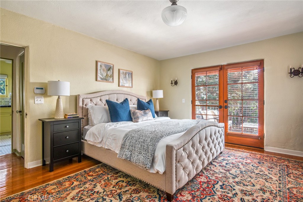 8246 4th Street Los Angeles, CA 90048 - Photo 23 of 38 a bedroom with a bed and a lamp with the wooden floor
