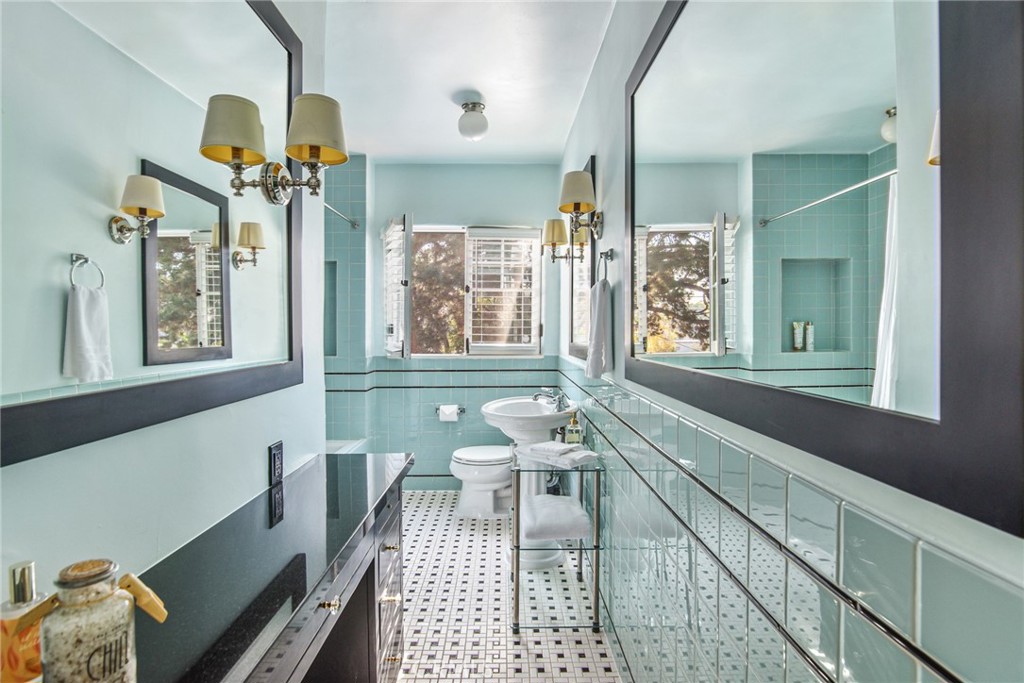 8246 4th Street Los Angeles, CA 90048 - Photo 26 of 38 a bathroom with a sink mirror and a bathtub next to a window