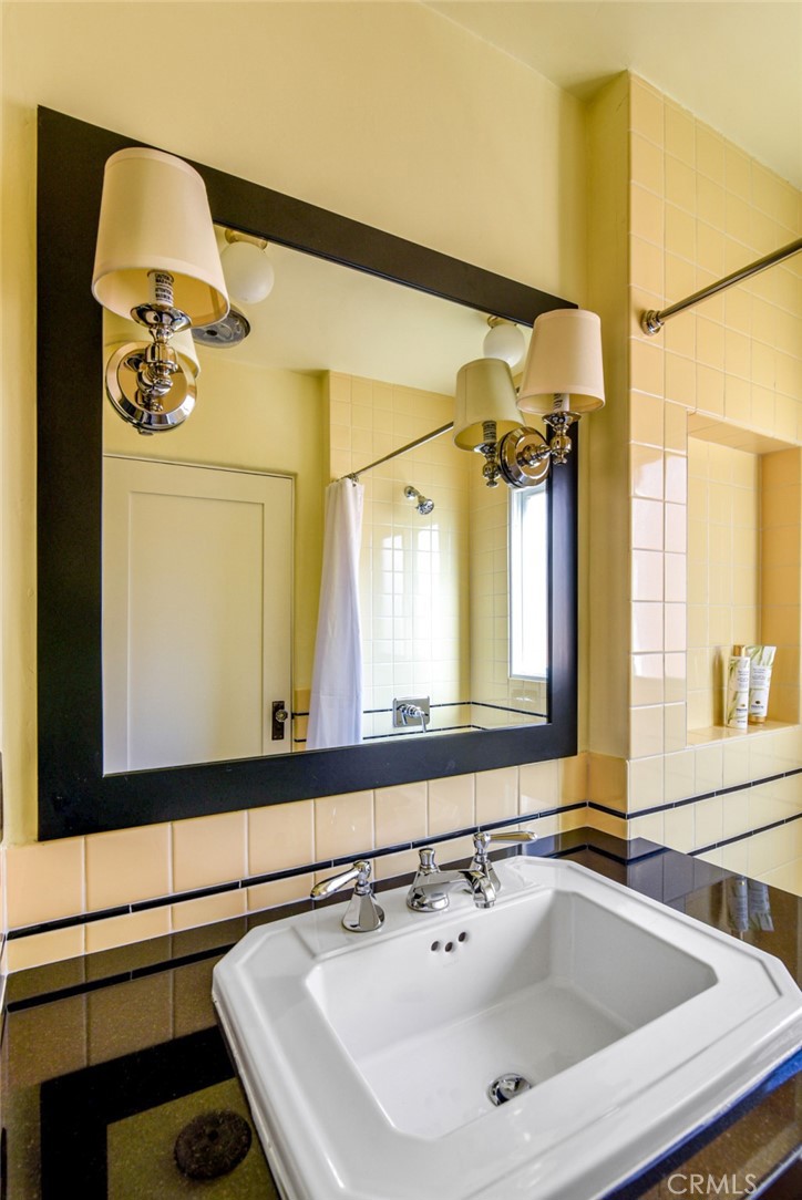 8246 4th Street Los Angeles, CA 90048 - Photo 33 of 38 a bathroom with a sink and a mirror