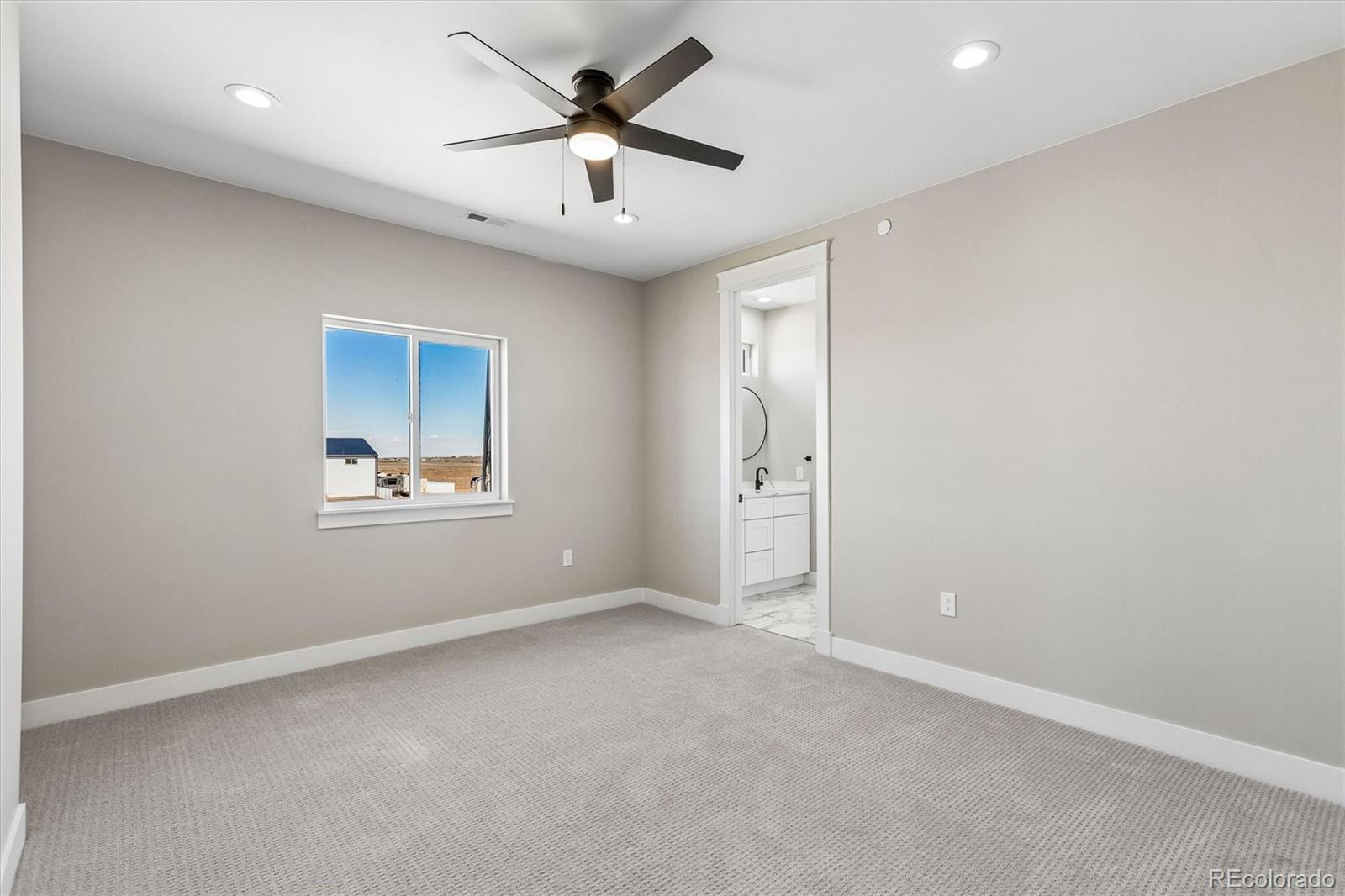 13350 Imboden Road Hudson, CO 80642 - Photo 28 of 50 an empty room with windows and fan