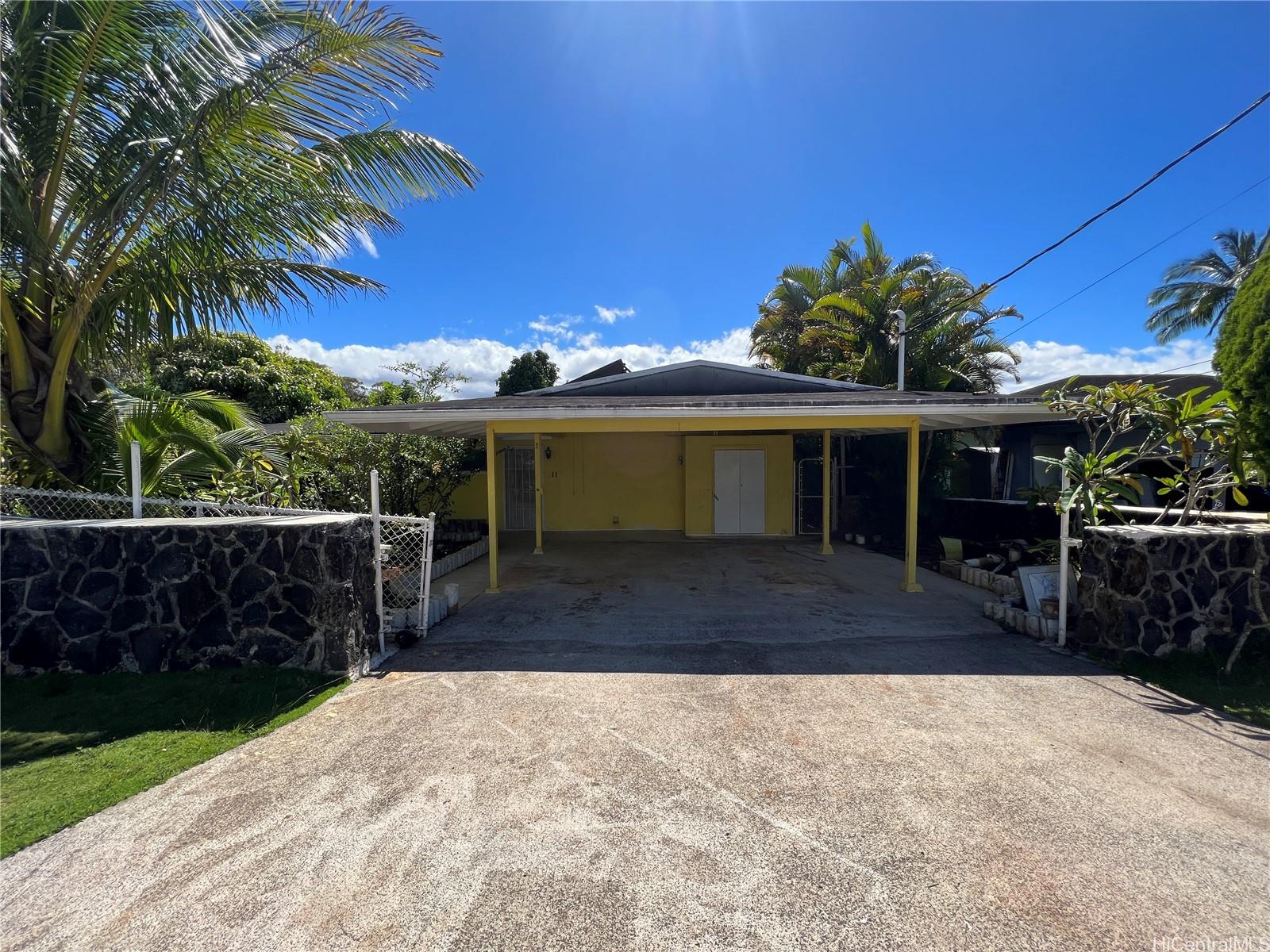 11 Haumalu Place Wahiawa, HI 96786 - Photo 1 of 15 a front view of a house with a yard and potted plants