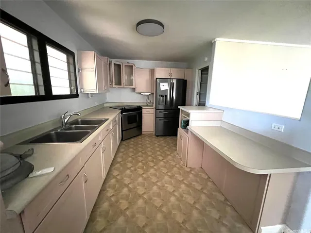 a large white kitchen with a large window