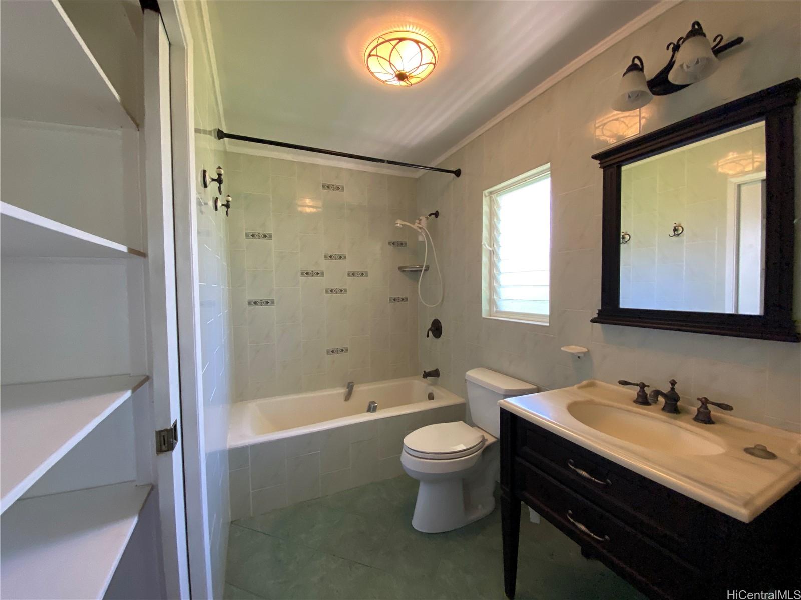 11 Haumalu Place Wahiawa, HI 96786 - Photo 6 of 15 a bathroom with a sink a toilet and a bathtub