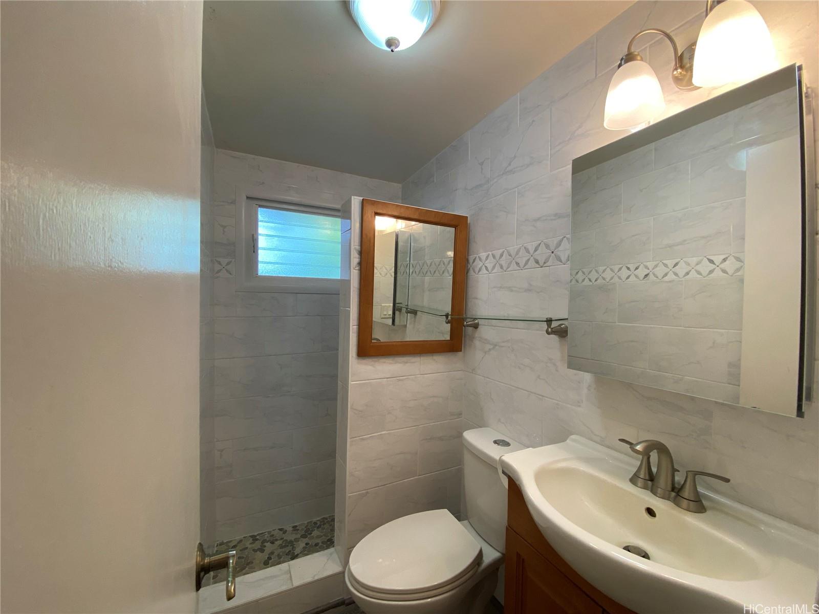 11 Haumalu Place Wahiawa, HI 96786 - Photo 10 of 15 a bathroom with a toilet sink and mirror