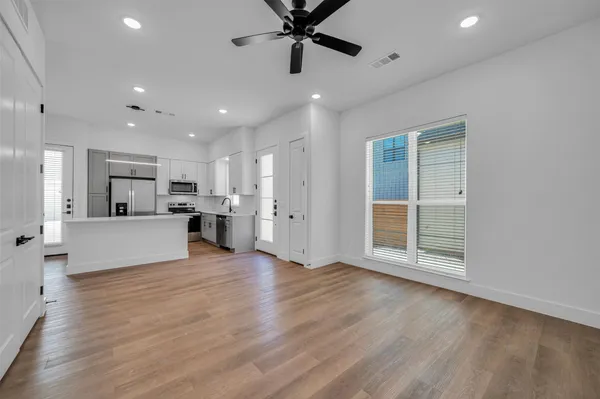 a large kitchen with stainless steel appliances a large counter top stove and cabinets