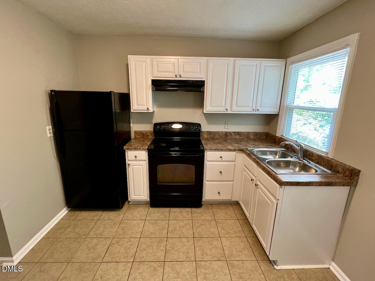 1320 Poole Road, Unit L Raleigh, NC 27610 - Photo 4 of 12 a kitchen with a refrigerator sink and stove
