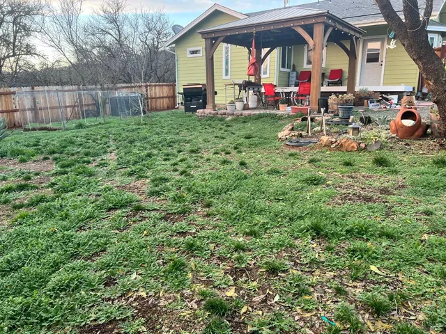 a view of a house with backyard and porch
