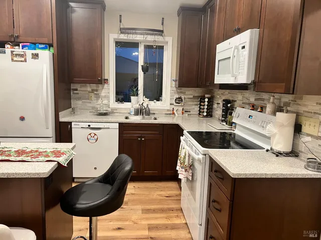 a kitchen with a sink cabinets and wooden floor