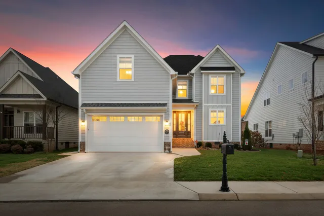 a front view of a house with a yard and garage
