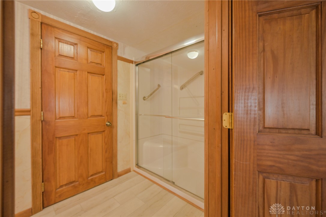 3057 Springfield Xenia Road Springfield, OH 45506 - Photo 16 of 37 This bathroom features a sleek glass-enclosed shower and durable wood flooring.