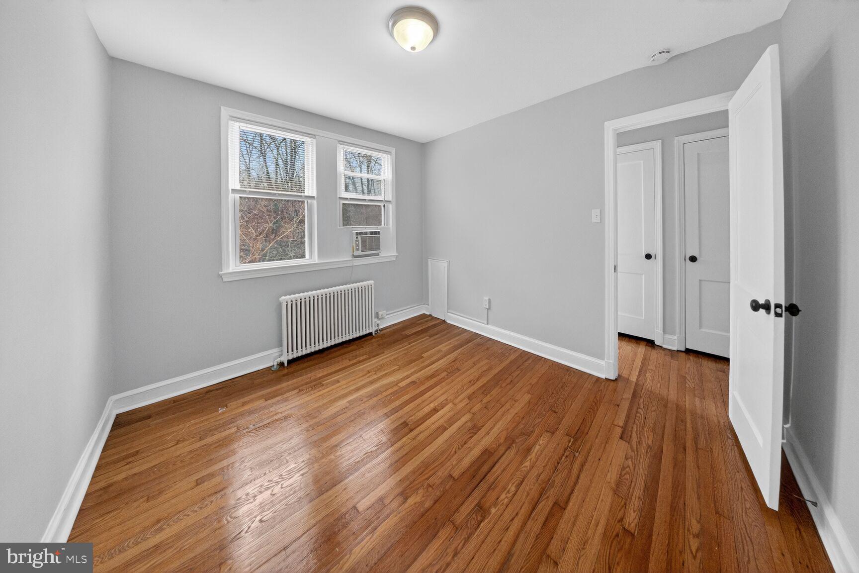 4703 Ravenswood Road, Unit 25 Riverdale, MD 20737 - Photo 11 of 12 wooden floor in an empty room with a window